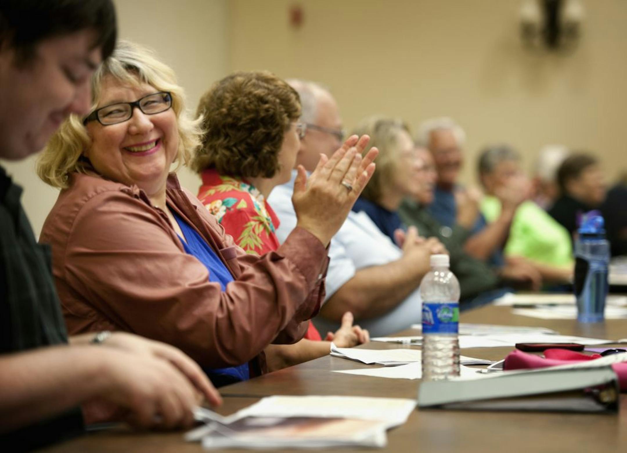 Carol Hanson applauded at a Cedar Falls Tea Party meeting on Sept. 13. Hanson switched her allegiance from Michele Bachmann to Ron Paul because Bachmann voted to renew the Patriot Act.