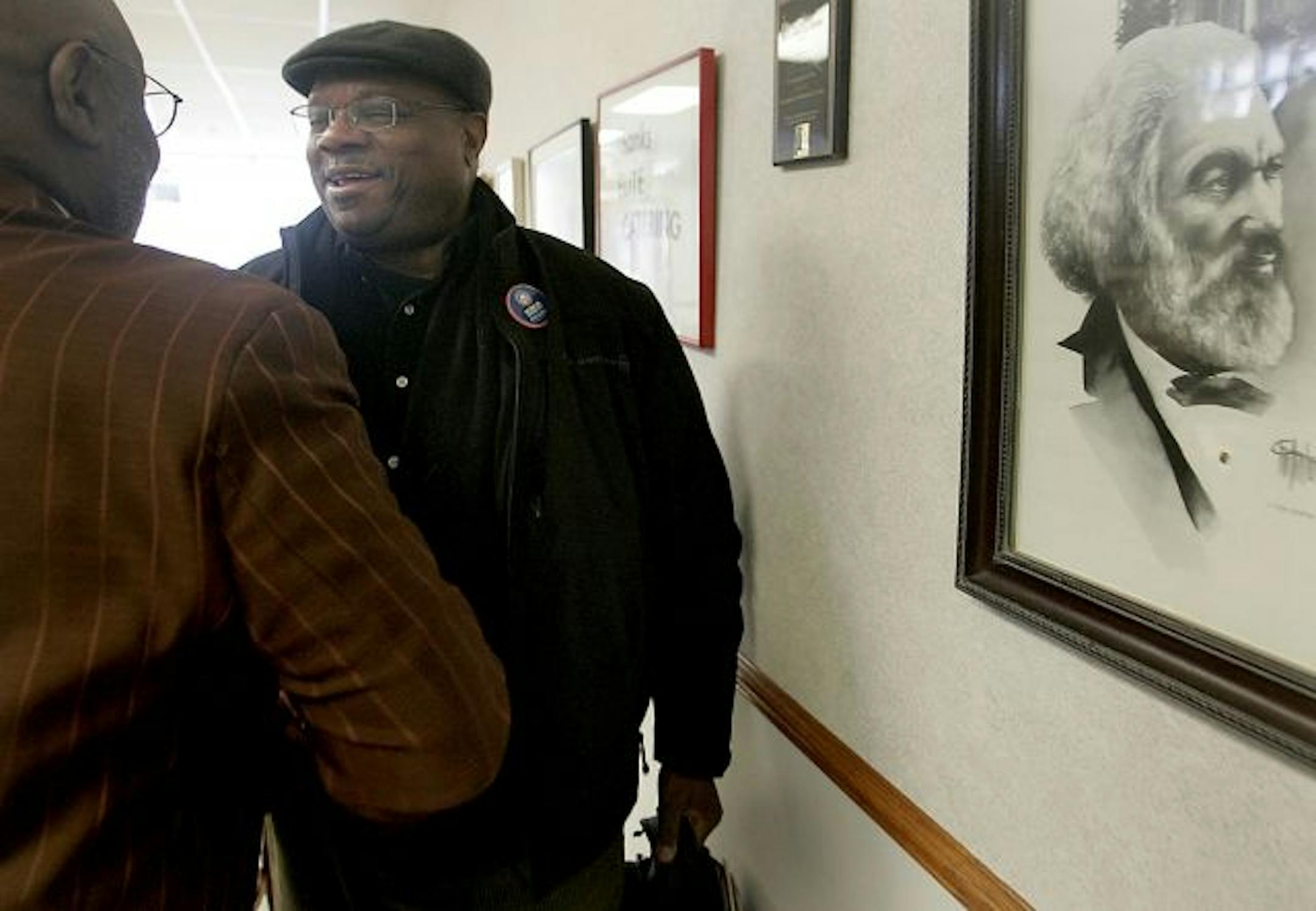 Insight News publisher Al McFarlane greeted Rev. Charles Ford, left, at their weekly community meeting. "The mission to challenge oppressive ideas is ongoing," said McFarlane.