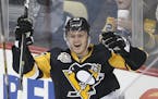 Pittsburgh Penguins' Jake Guentzel (59) celebrates his first goal in the NHL on his first shot in his first NHL shift during the first period of an NH