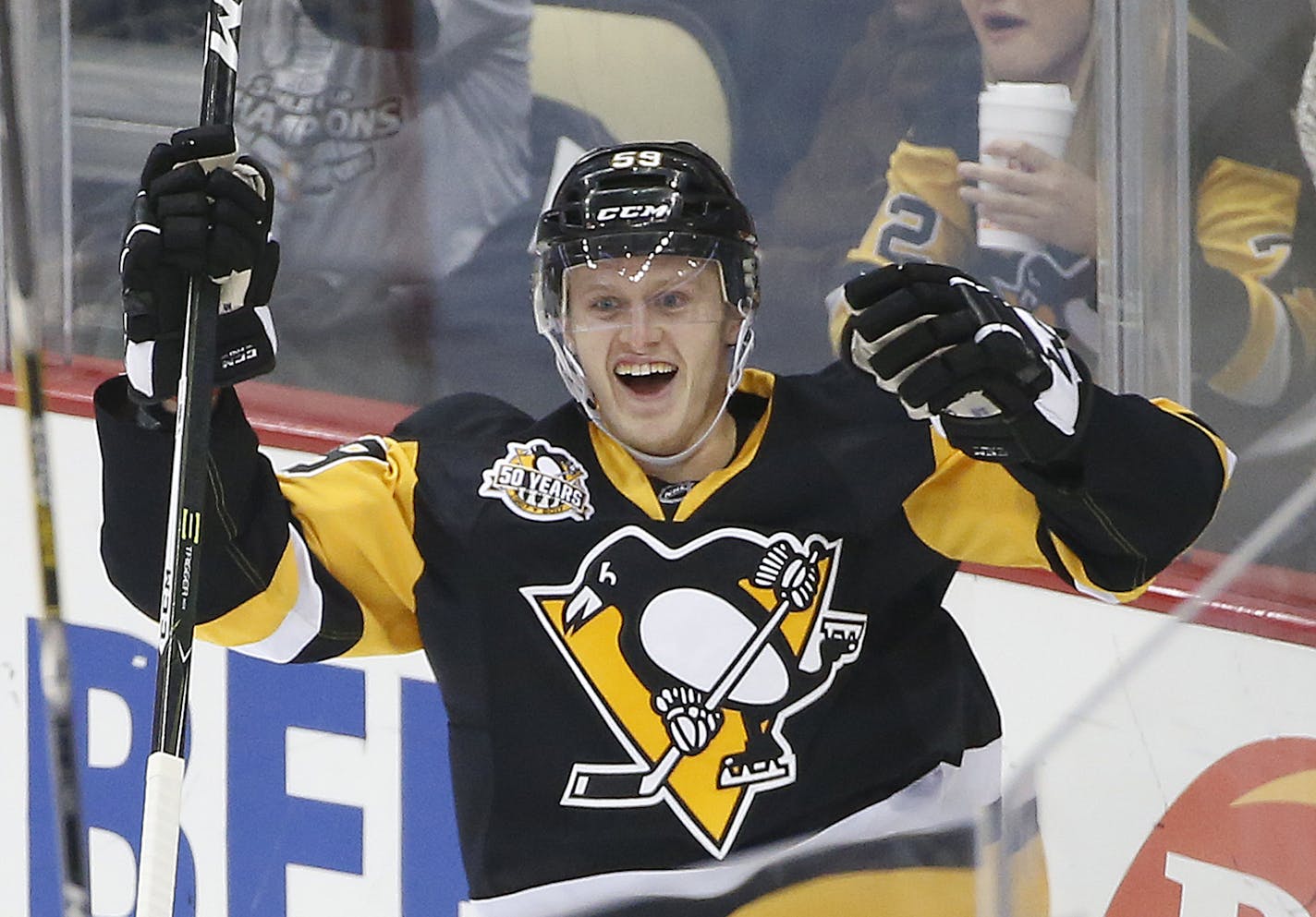 Pittsburgh Penguins' Jake Guentzel (59) celebrates his first goal in the NHL on his first shot in his first NHL shift during the first period of an NHL hockey game against the New York Rangers in Pittsburgh, Monday, Nov. 21, 2016. (AP Photo/Gene J. Puskar)