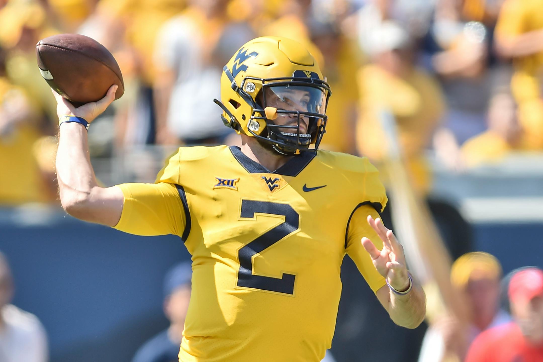 West Virginia quarterback Jarret Doege (2) makes a pass against Virginia Tech during the first half of an NCAA college football game in Morgantown, W.Va., Saturday, Sep. 18, 2021. (AP Photo/William Wotring)