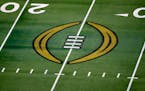 The College Football Playoff logo is shown on the field at AT&T Stadium before the Rose Bowl. The playoff will expand from four teams to 12 next seaso