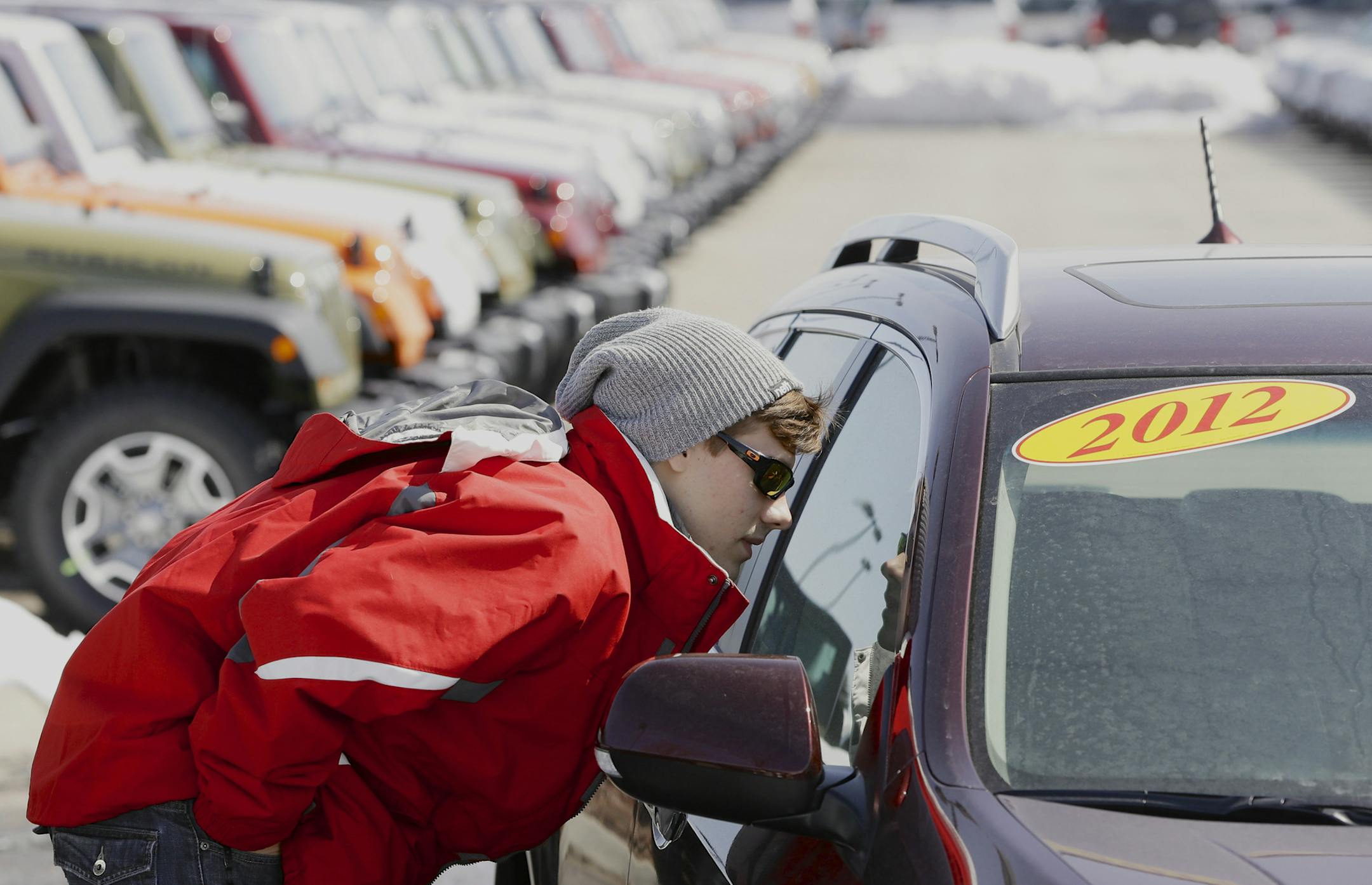 In this Thursday, March 14, 2013, photo, Matthew Miller of Omaha shops for a car in Omaha, Neb. March is turning out to be the best month for auto sales in at least six years. Major automakers including Ford, Chrysler, Toyota, General Motors and Nissan all reported increases, with some reporting their best month since the start of the Great Recession in December of 2007. (AP Photo/Nati Harnik)