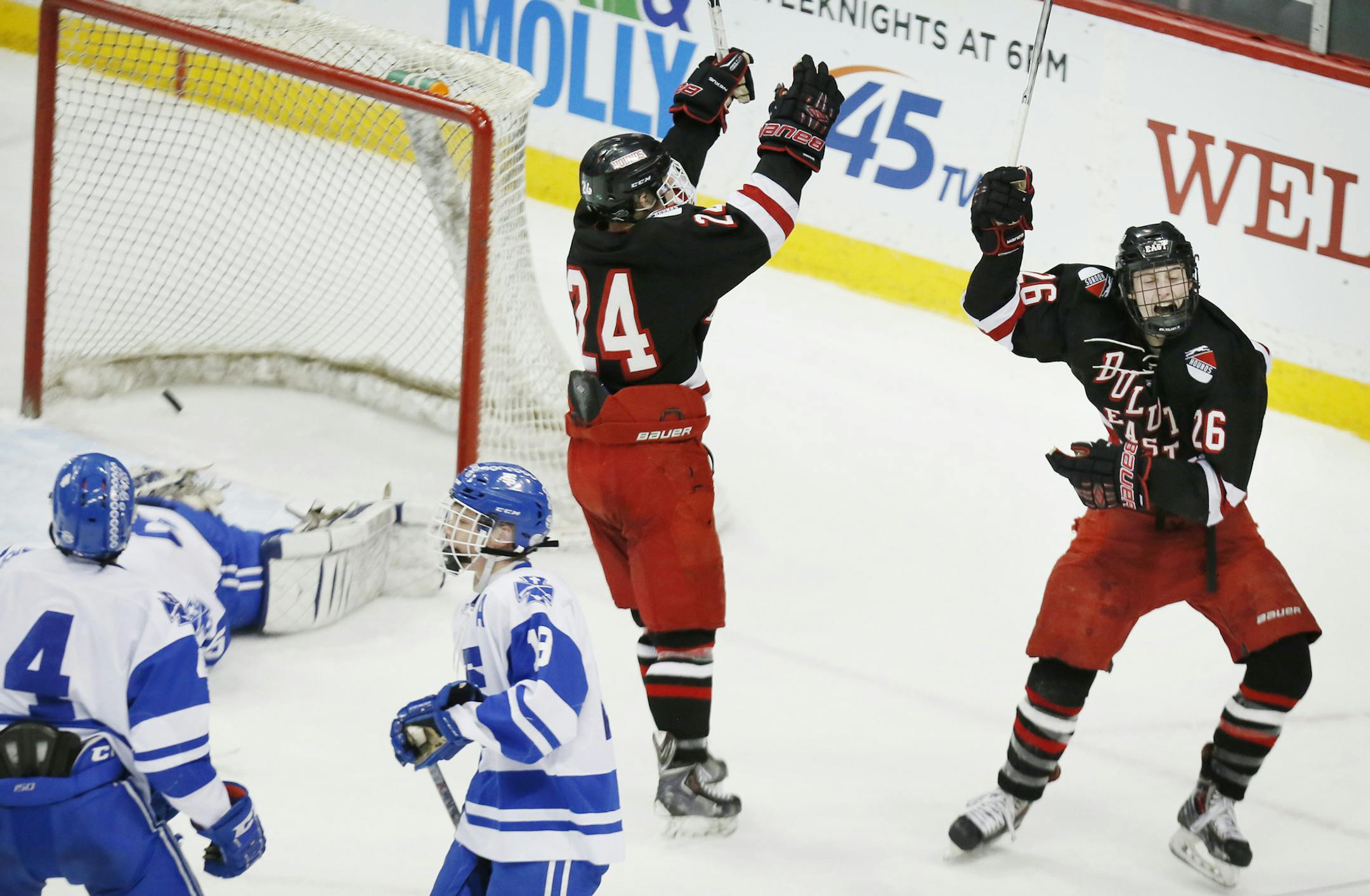 Ryan Peterson of Duluth East left celebrated with Ash Altmann after scoring the winning goal in overtime on STA goalkeeper Matt Snow. Duluth East beat St. Thomas Academy 6-5 in overtime in Class 2A quarterfinals boy's hockey state tournament at the Xcel Energy Center Thursday March 5, 2015 in St. Paul, Minnesota. ] Jerry Holt/ Jerry.Holt@Startribune.com