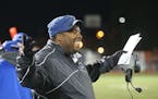 Minneapolis North High Charles Adams, who is also a Minneapolis police officer, celebrates a team touchdown during a game with St. Paul Central in St.