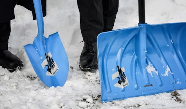 MLS Commissioner Don Garber, used his Minnesota United snow shovel, customized for the coldest ground breaking anyone could remember. ] GLEN STUBBE * 