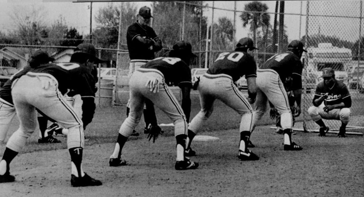 Lou Brock worked with some Twins players during 1986 spring training. The players (right to left) were Kirby Puckett, Billy Beane, Ron Washington and minor leaguer Alex Marte. Watching was Charlie Manuel, who was manager of the Class AAA Toledo team.