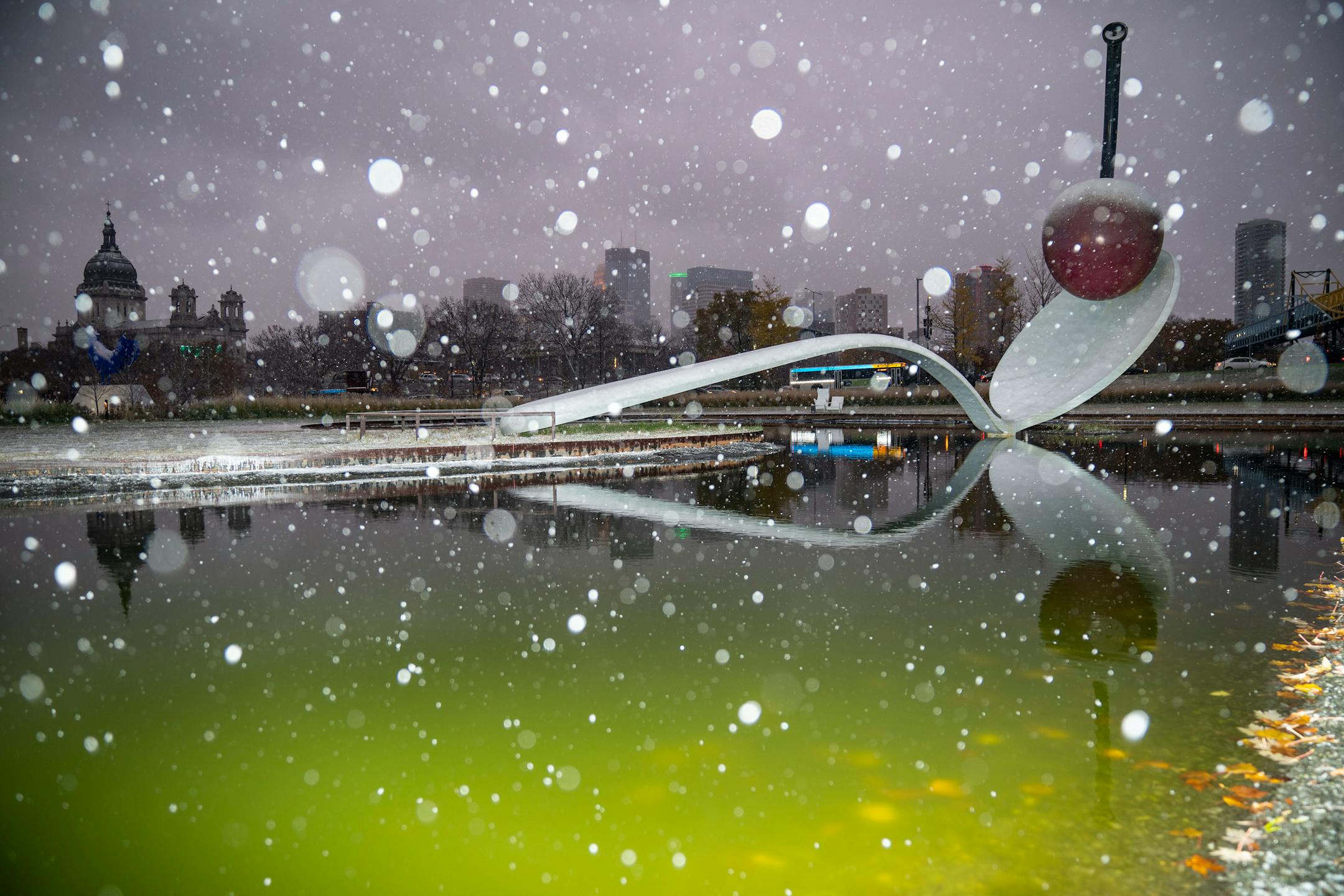 Snow lightly fell on the "Spoonbridge and Cherry" sculpture in the Walker Art Center sculpture garden during the first winter storm of the season on Saturday, Nov. 13, 2021.