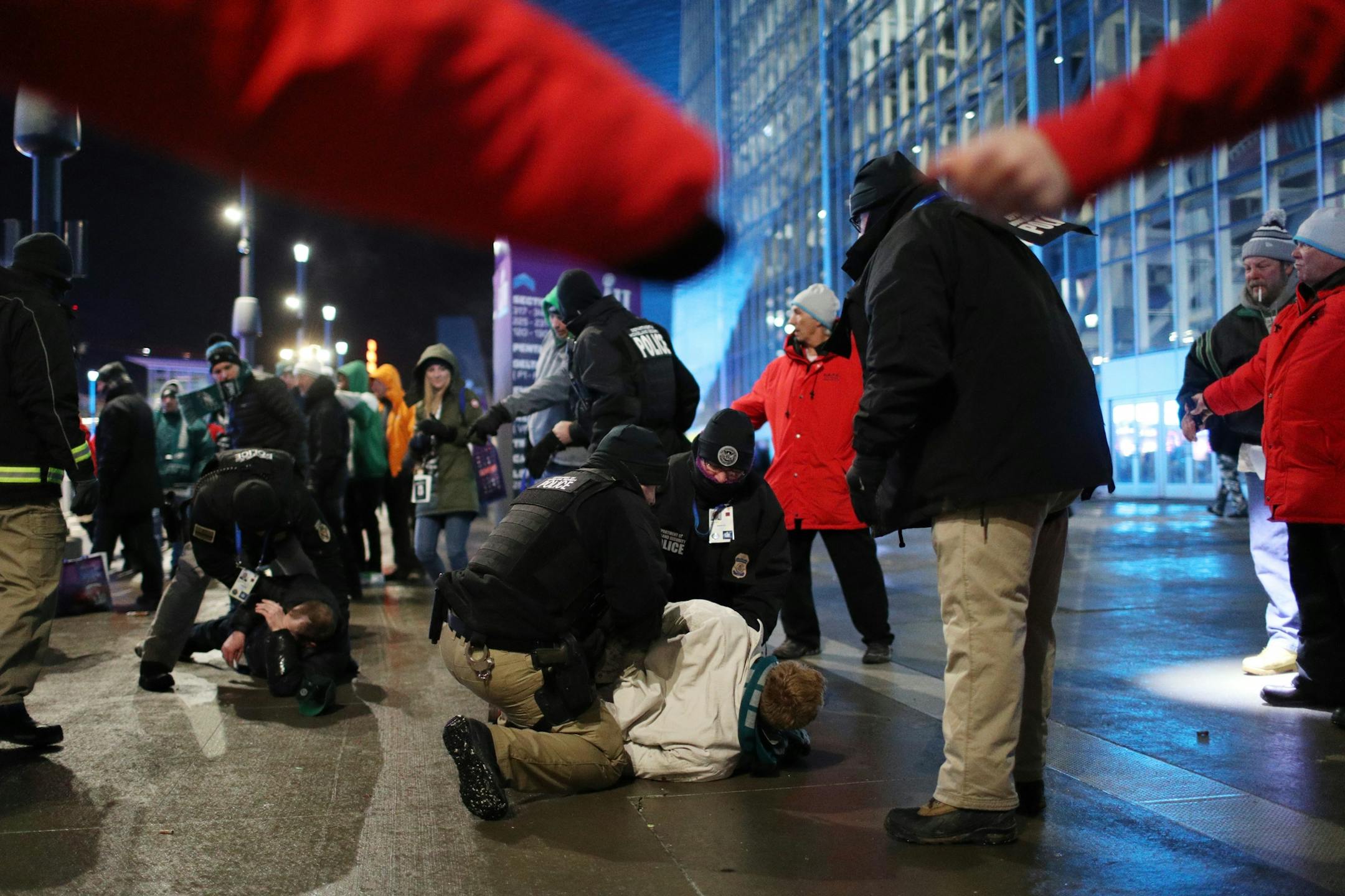 Police detained two men after another was knocked unconscious during a fight as fans left U.S. Bank Stadium after Super Bowl 52.