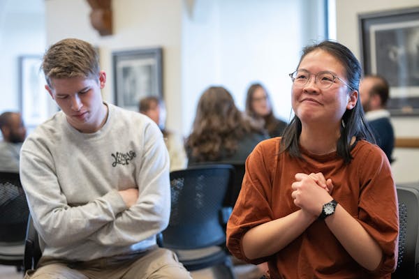 Bobby Byrne, a senior, listens to Gloriana Ye, also a senior, as she leads a discussion Wednesday during a Death Cafe meeting at St. Olaf College in N