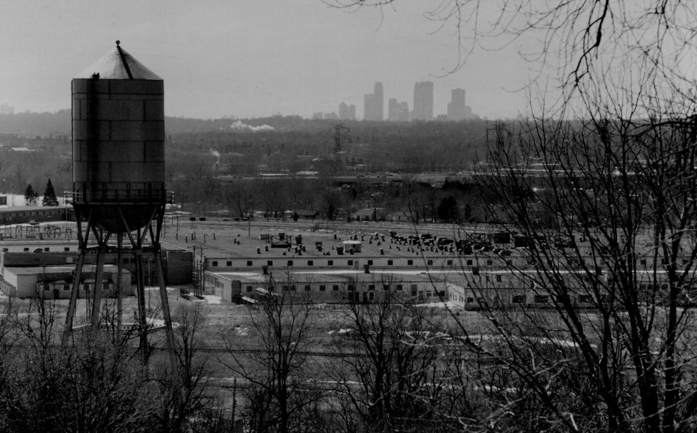 March 10, 1994 Twin Cities Army Ammunition Plant, Arden Hills. The Army no longer has any use for much of the 2,000 acres of the old "arsenal" and is considering turning it over to some other agency. The city of Arden Hills, for instance, wants some of the land for a new city hall. A group of conservationists want to preserve the wetlands and native prairie there. Seen from the top of a kame (a glacial hill) on the arsenal grounds, plant buildings in the foreground and the Mpls. skyline in back.