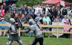 A large crowd watched two knights battle at the end of the jousting competition.
