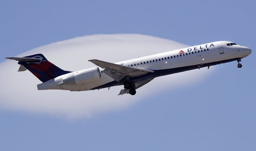 FILE- In this May 24, 2018, file photo a Delta Air Lines passenger jet plane, a Boeing 717-200 model, approaches Logan Airport in Boston. Delta Air Lines Inc. (DAL) on Thursday, Oct. 11, 2018, reported third-quarter earnings of $1.31 billion. (AP Photo/Charles Krupa, File)