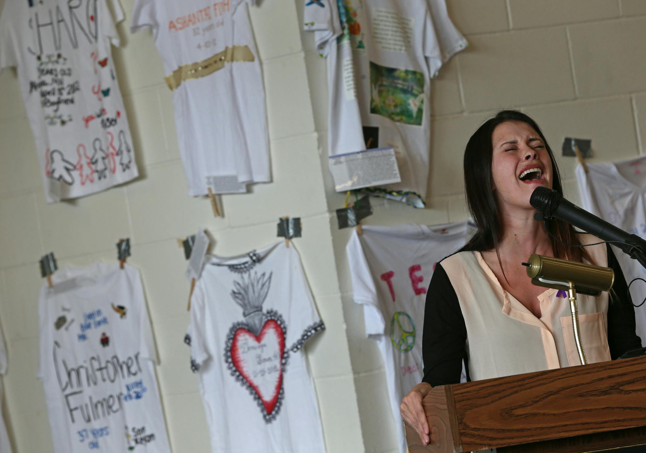 Brittani Senser sang during the closing moments of a ceremony commemorating Domestic Violence Awareness Month at St. Paul Fire Station No. 1.