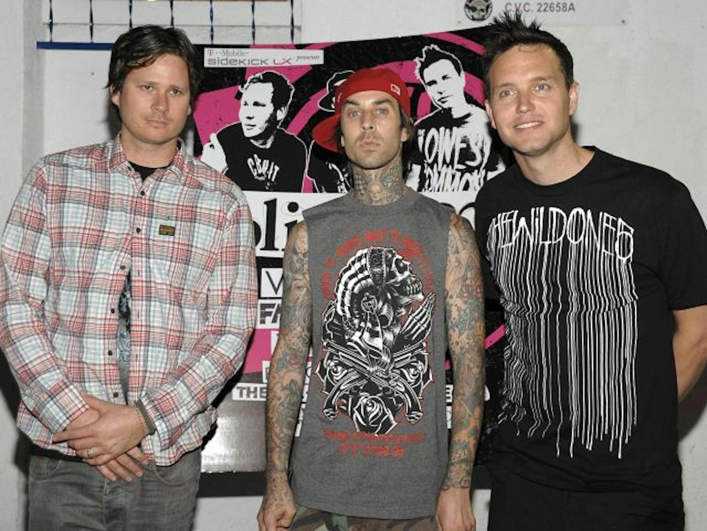 Tom DeLonge, left, drummer Travis Barker, and singer and musician Mark Hoppus, right, of the rock band Blink-182 arrive at the Blink-182 tour launch party in Los Angeles.