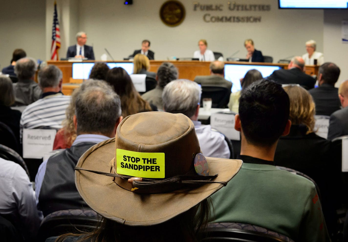 A 2015 Minnesota Public Utilities Commission meeting took testimony on whether Enbridge has proven the need for Sandpiper oil pipeline, which will cross some environmentally sensitive areas. An anti-pipeline Native American environmental group Honor the Earth protested outside, and then many members attended the hearing.