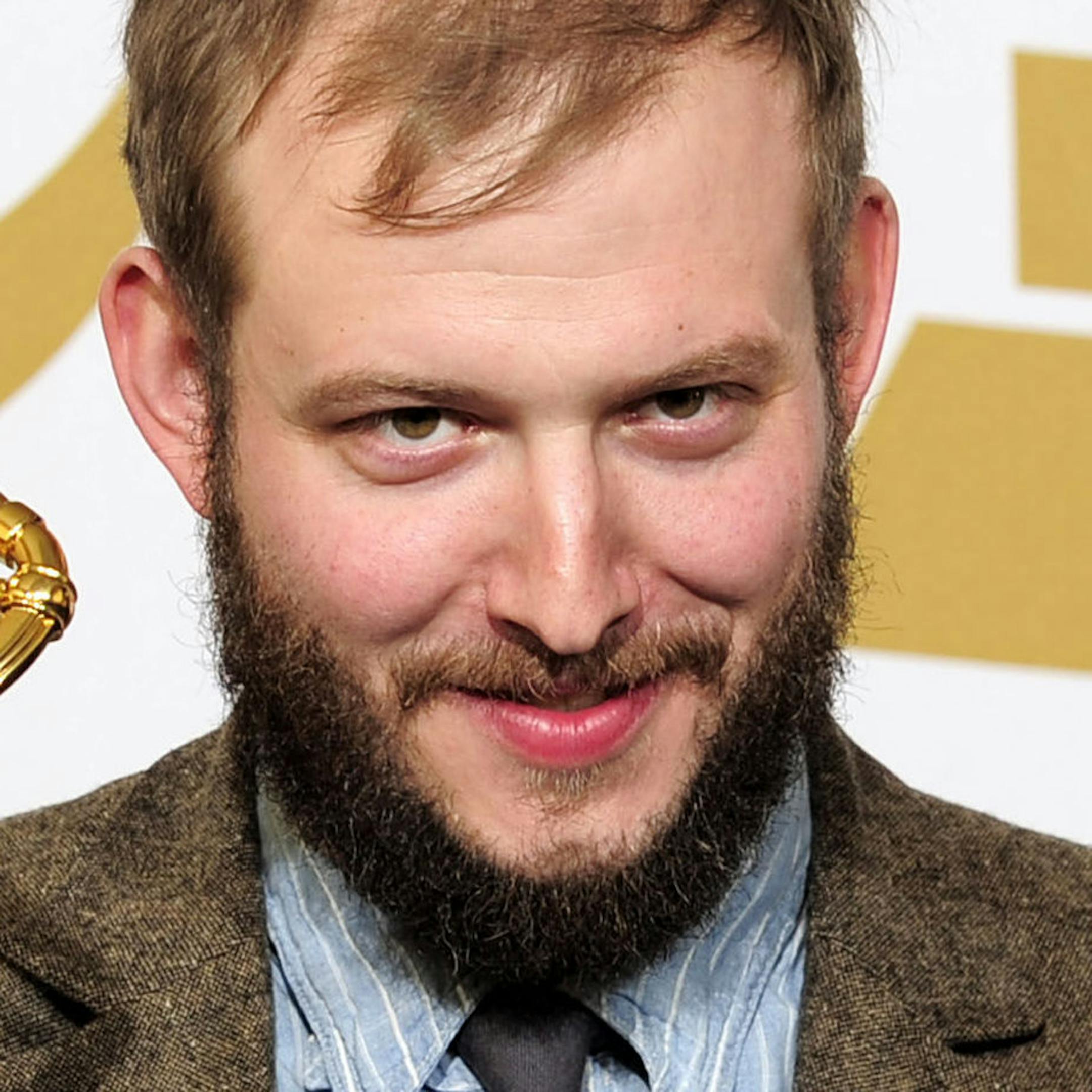 Justin Vernon poses backstage with the award for best alternative music album for "Bon Iver" at the 54th annual Grammy Awards on Sunday, Feb. 12, 2012 in Los Angeles. (AP Photo/Mark J. Terrill)