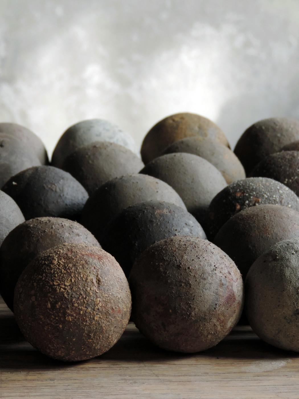 A handout photo provided by the ceramic artist Mitch Iburg shows raw, unfired clay spheres, which reveal the diversity of the materials that Iburg extracts from a mine in Minnesota.