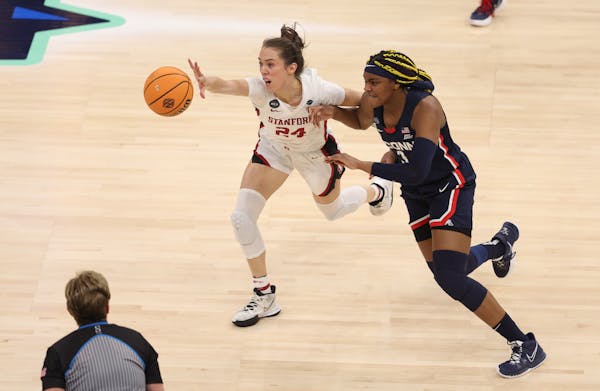 Stanford guard Lacie Hull and UConn forward Aaliyah Edwards fight for the ball during Friday's semifinal game