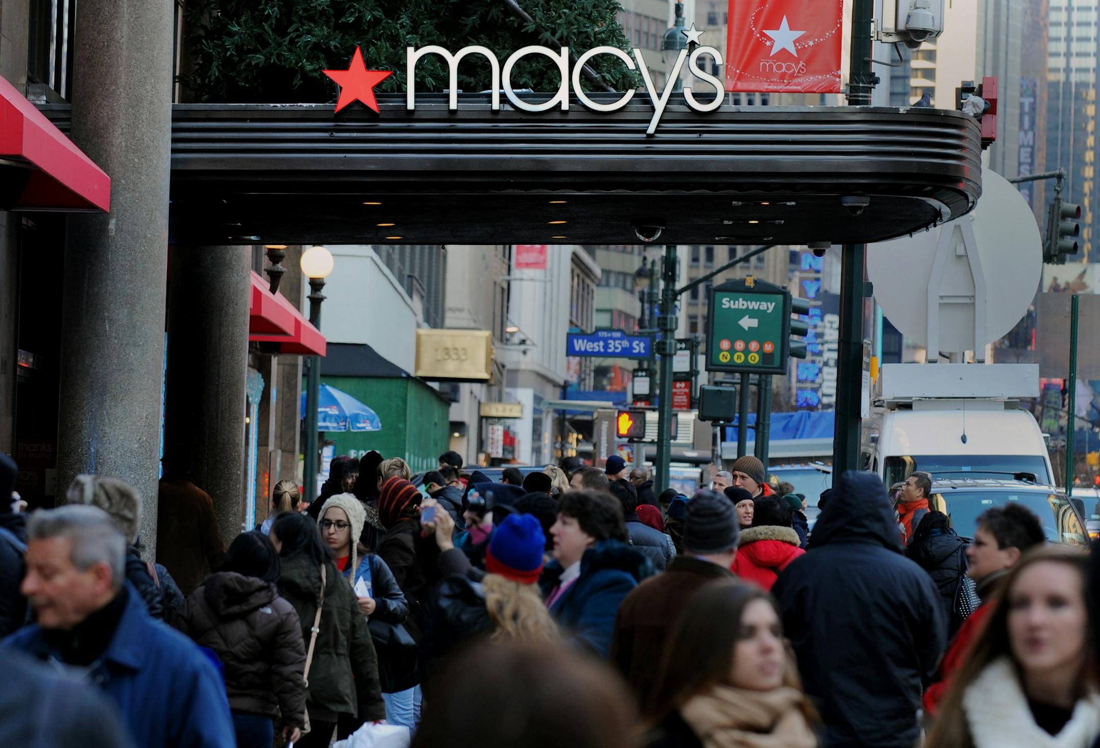 Pedestrians walk past Macy's Inc. flagship store in New York, U.S., on Thursday, Nov. 29, 2013. Terry Lundgren, president and chief executive officer of Macy's Inc., said 15,000 shoppers waited to enter its Herald Square store in New York at 8 p.m. last night, up from 11,000 at midnight a year earlier. Photographer: Peter Foley/Bloomberg