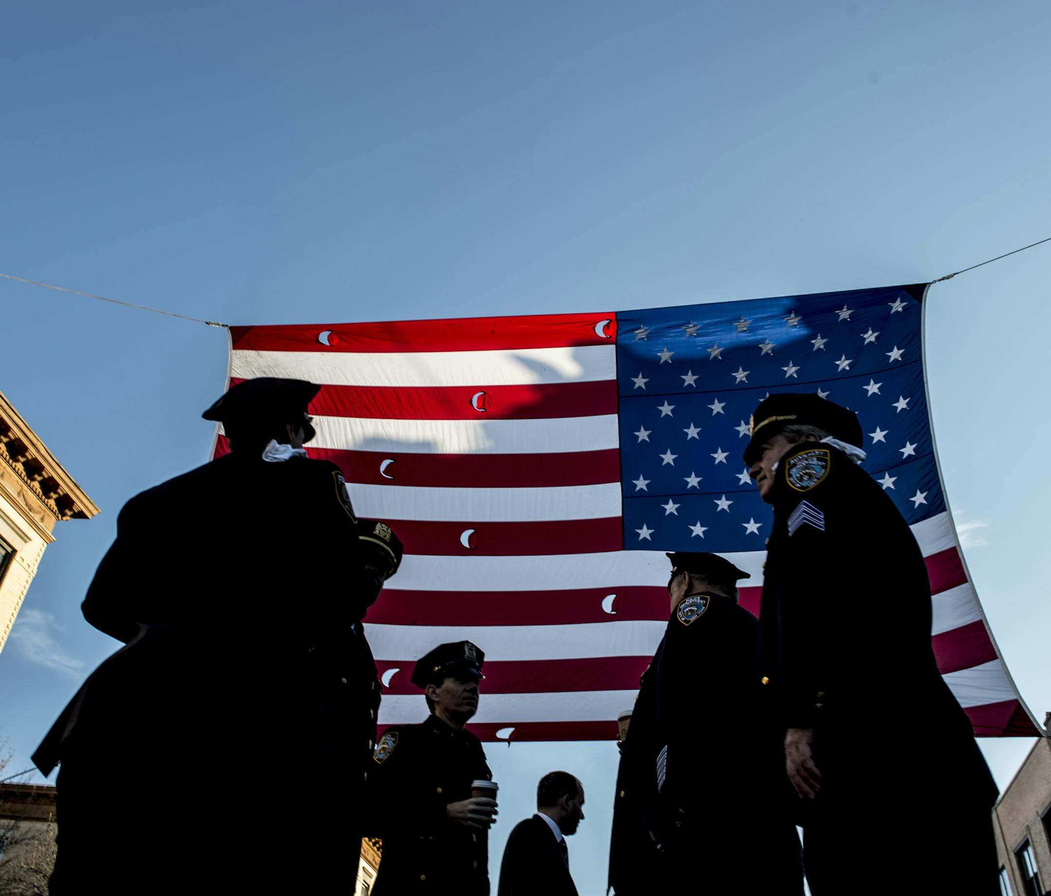 New York Police Department personnel gather outside Christ Tabernacle Church for the funeral of Officer Rafael Ramos, in the Queens borough of New York, Dec. 27, 2014. Ramos had been on the force for nearly three years when he and his patrol partner, Wenjian Liu, were shot dead by an unstable man who had vowed online to kill police officers. (Robert Stolarik/The New York Times)