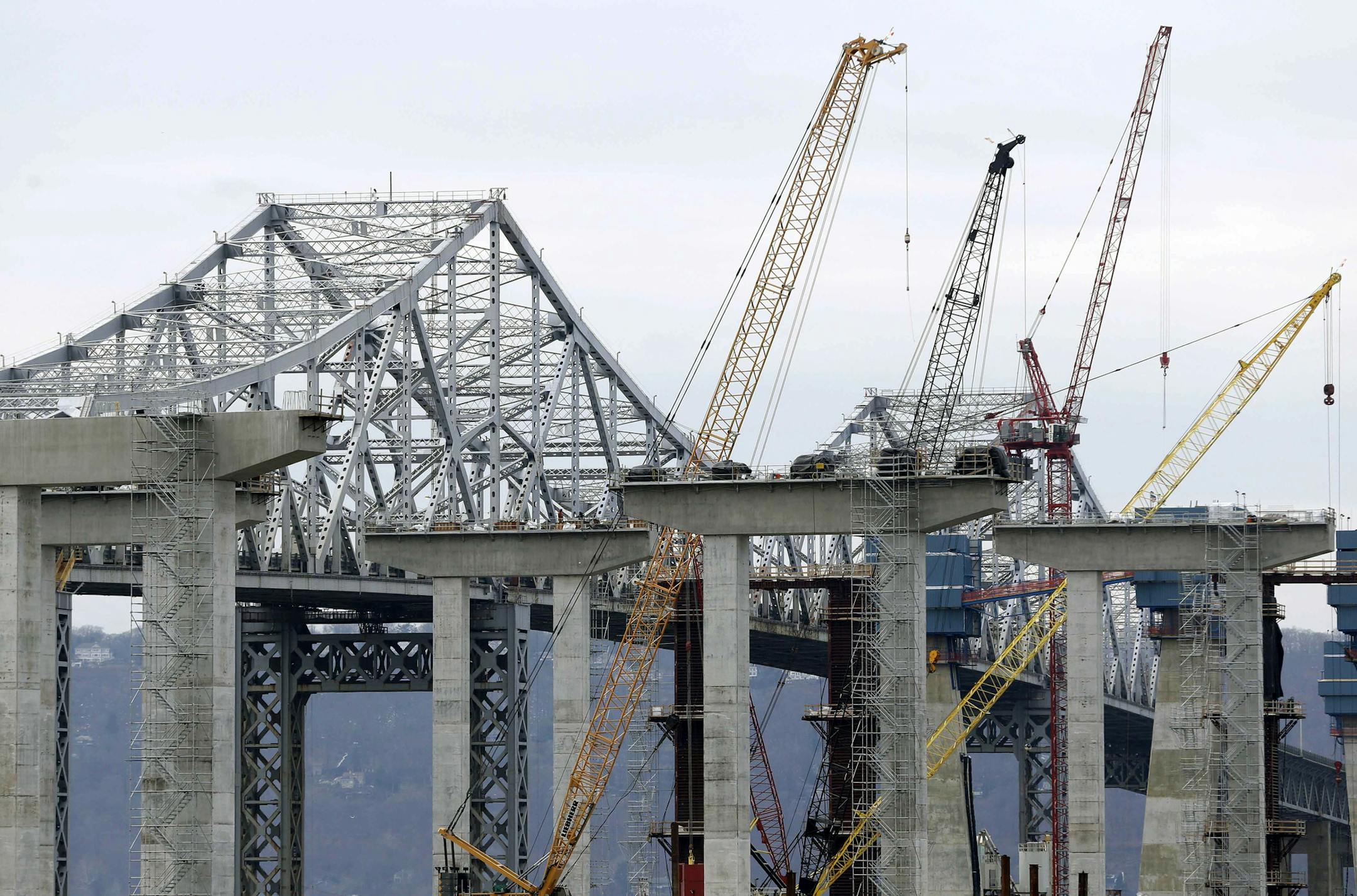 FILE- In this Jan. 14, 2016 file photo, construction continues on the new Tappan Zee Bridge as it is seen from Tarrytown, N.Y. New York Gov. Andrew Cuomo has launched efforts to rebuild Kennedy and LaGuardia airports, remodel and expand Penn Station, and replace the Tappan Zee Bridge. Federal support could be critical to getting the work done, and Cuomo, a Democrat, says he hopes Republican president-elect Donald Trump understands the need to help. (AP Photo/Seth Wenig, File)
