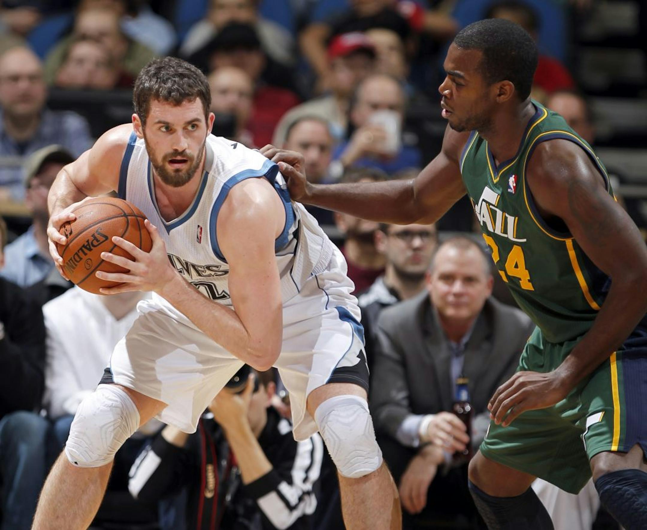 Wolves forward Kevin Love (42) was defended by Utah's Paul Milsap (24) in the first quarter Wednesday night.