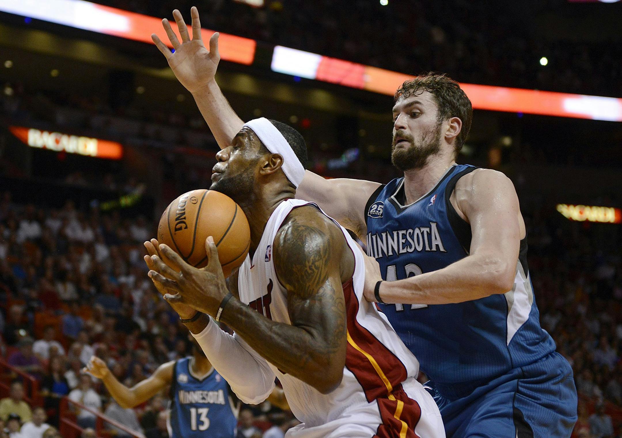 The Miami Heat's LeBron James bobbles the ball in front of the Minnesota Timberwolves' Kevin Love during the first half on Friday, April 4, 2014, at AmericanAirlines Arena in Miami. (Michael Laughlin/Sun Sentinel/MCT) ORG XMIT: 1151312