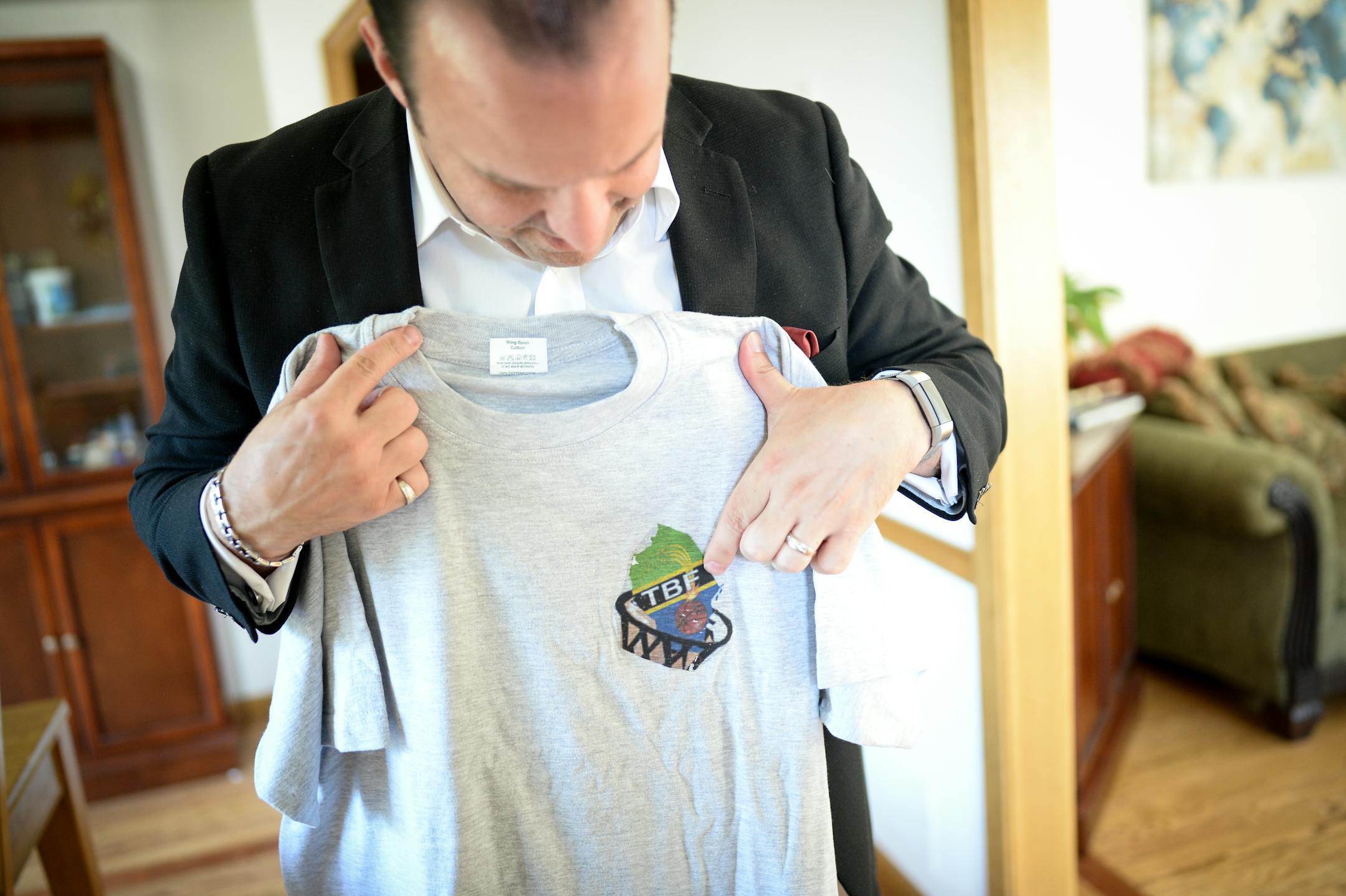 Matthew McCollister, a Twin Cities attorney and boys' basketball coach at Brooklyn Center, showed off a T-shirt from the Tanzania Basketball Federation.