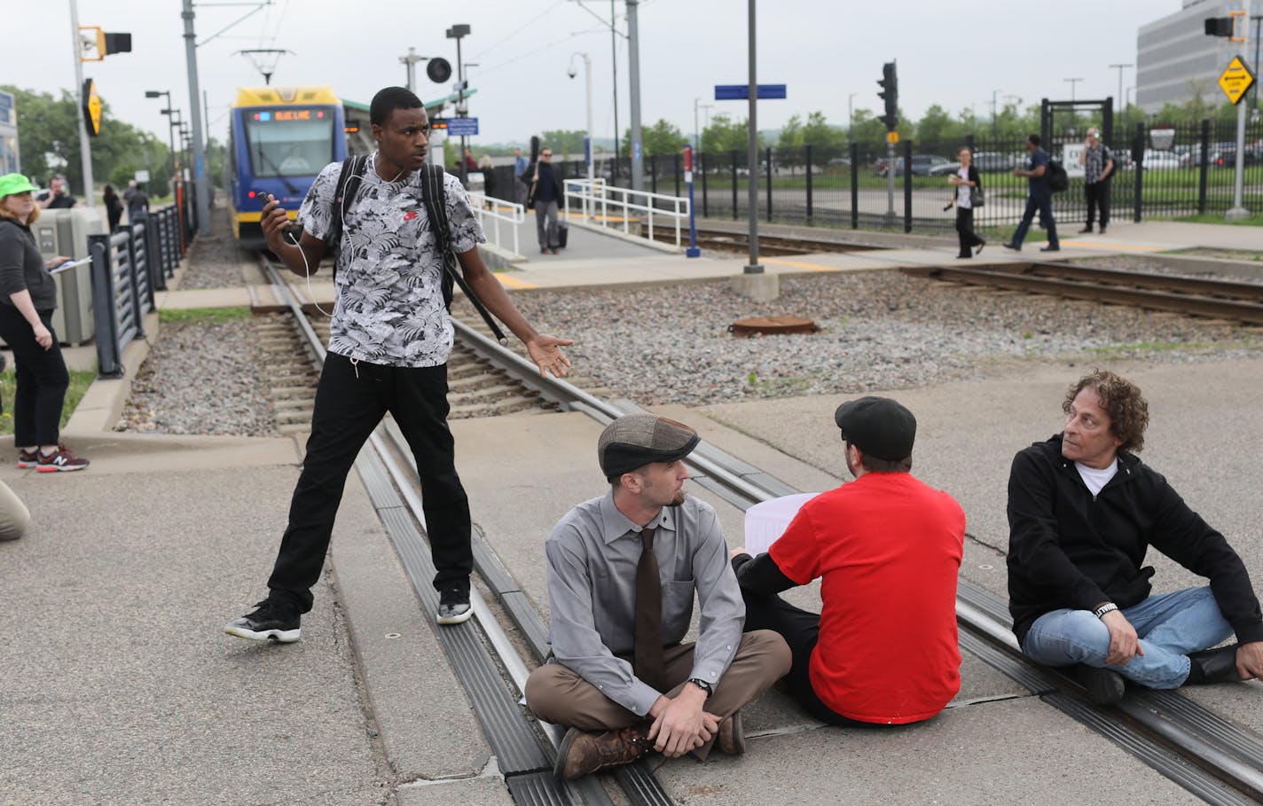 A frustrated commuter who had been on a light rail train asked demonstrators to move off the track so the train could proceed before law enforcement officials began arresting protestors who had shut down the light rail at the Fort Snelling light rail station by blocking the train tracks Tuesday, May 22, 2018, in Minneapolis, MN. The protest was in response to ICE raids on undocumented immigrants in the U.S.] DAVID JOLES &#xef; david.joles@startribune.com protestors shut down light rail at Fort S