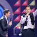 Ryan Seacrest, left, looks on as William Hung performs at the "American Idol" farewell season finale at the Dolby Theatre on Thursday, April 7, 2016, 