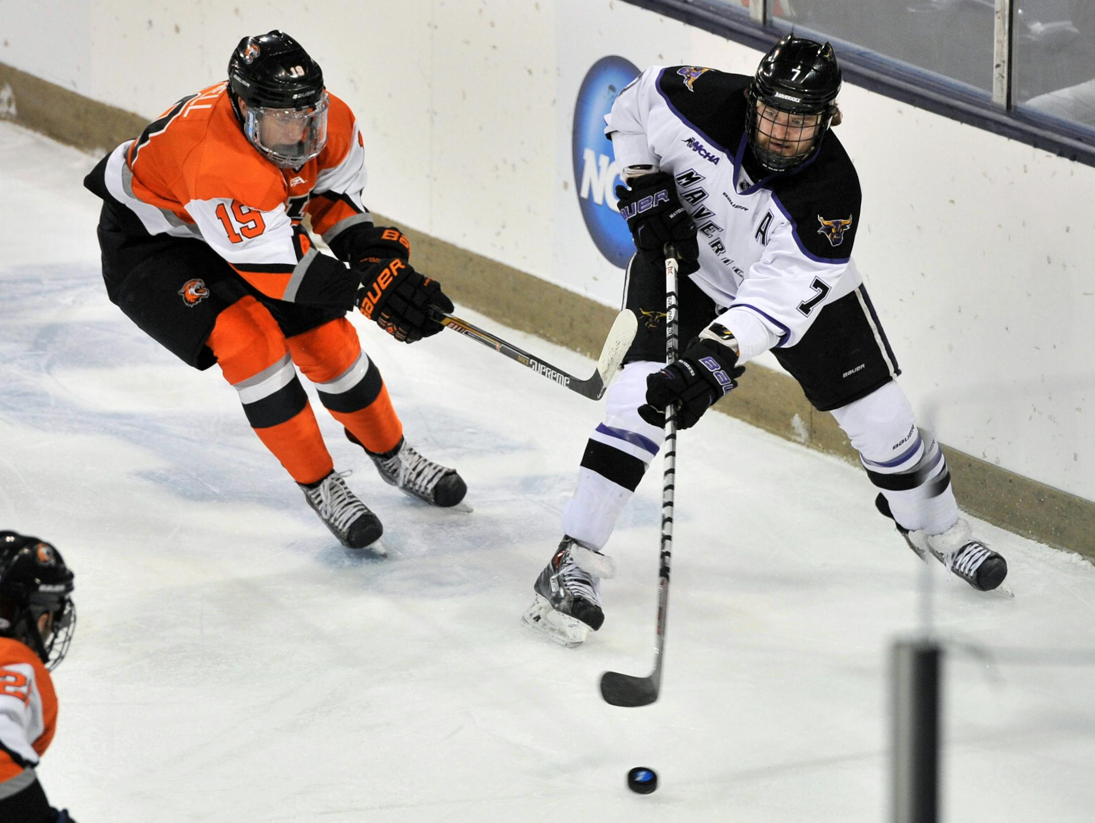 Minnesota State Mankato's Zach Palmquist (7) heads upice as RIT's Myles Powell defends during the regional semifinal in the NCAA college hockey tournament Saturday, March 28, 2015, in South Bend, Ind. (AP Photo/Joe Raymond)
