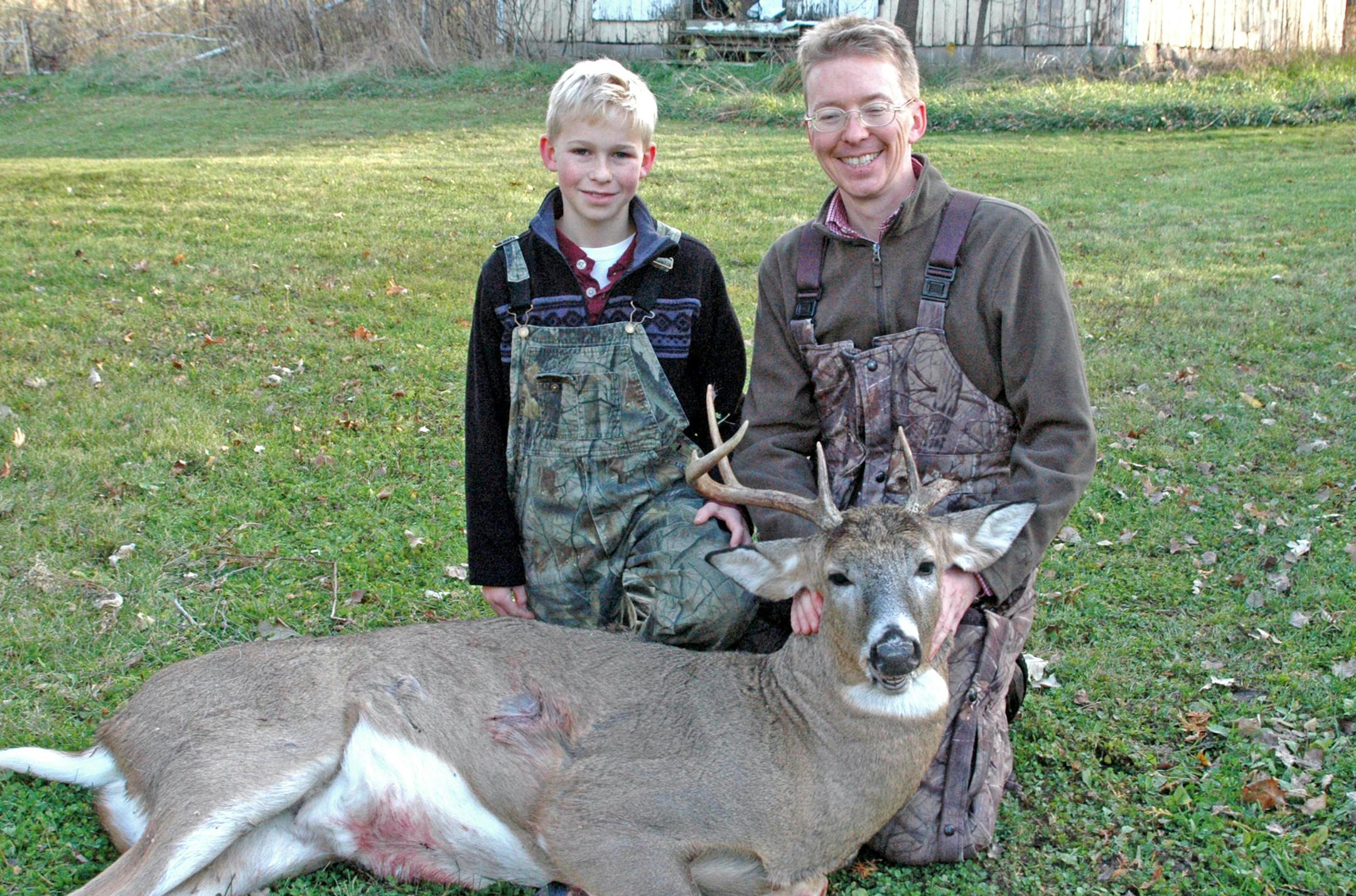 Christian Washburn, right, and the one-sided-antler buck his son, Aloysius, 12, felled in Washington County.