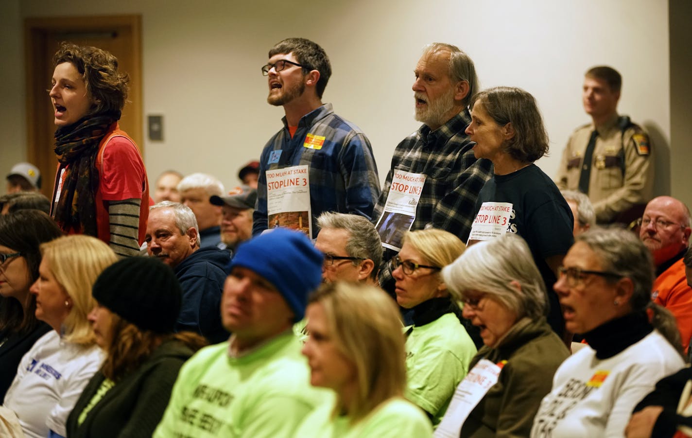 Paige Carlson, far left, and Andy Pearson, of MN350, a climate change environmental group, disrupted the ongoing discussions before leaving voluntarily.