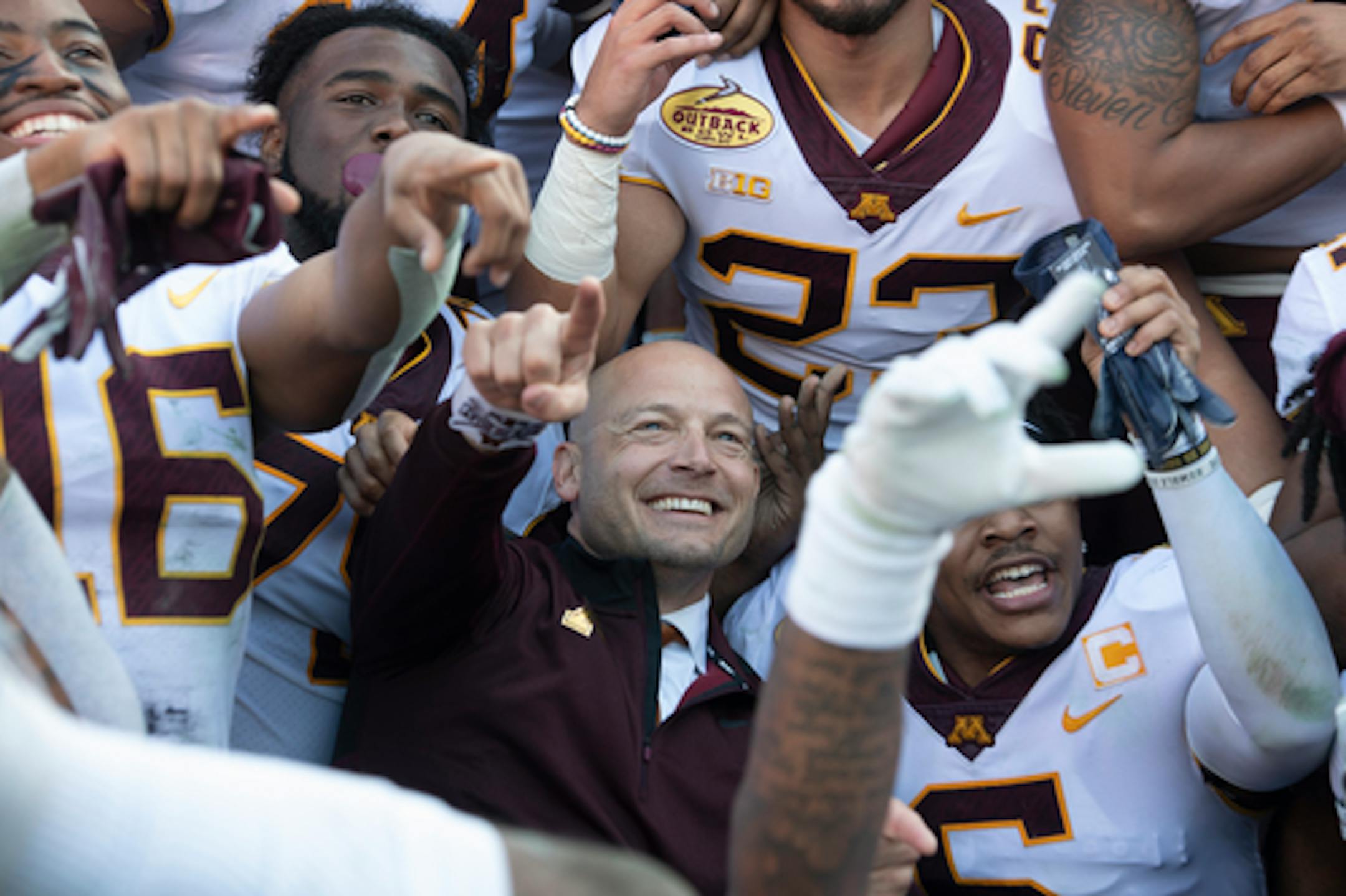Minnesota Gophers head coach PJ Fleck celebrated with his players during a team photo following their victory against the Auburn Tigers.
