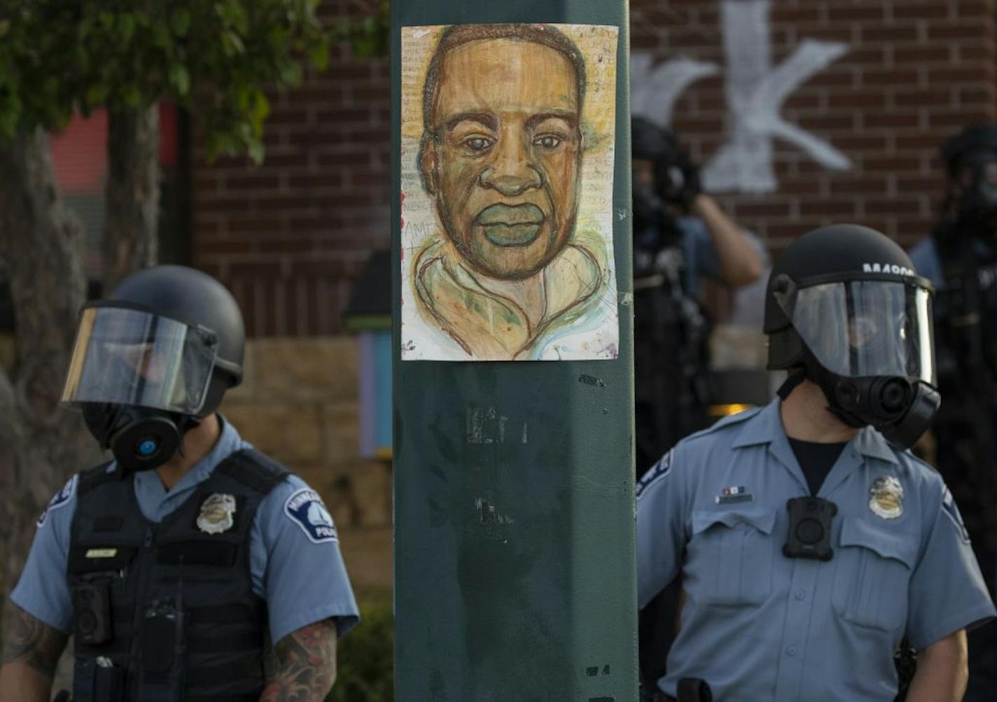 Officers in protective gear stood guard on May 27 at the Third Police Precinct station in Minneapolis.