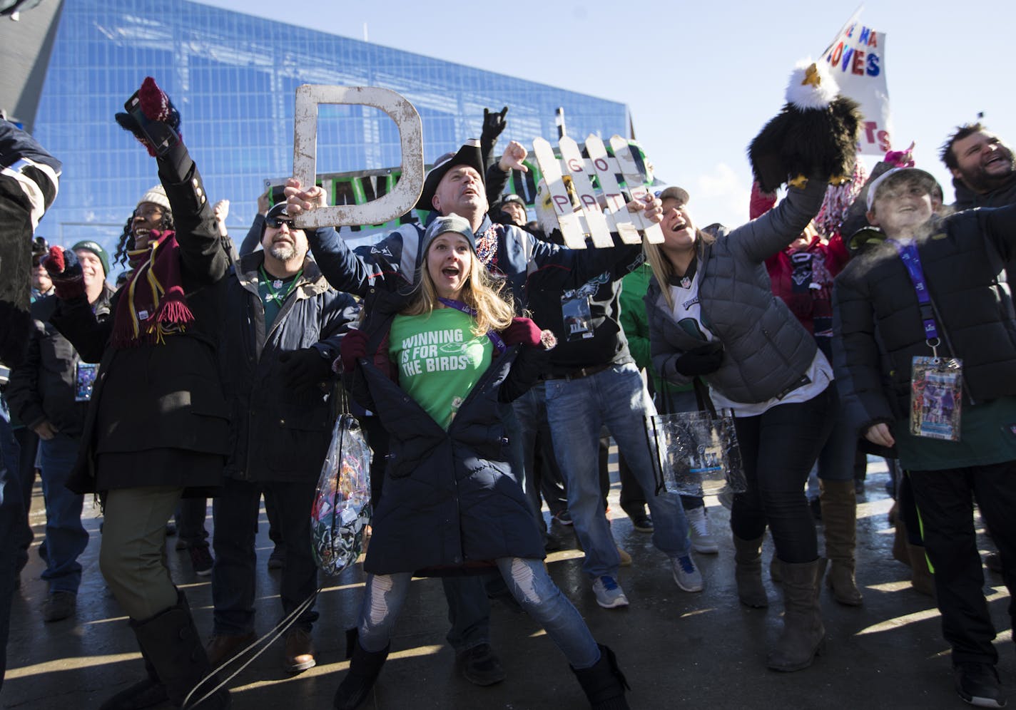 Eagles fan Megan McQueen, of Philadelphia, competed for airtime with Patriots fan John McDonald, of Revere, Mass., as they stood behind a live show out front of U.S. Bank Stadium for Super Bowl LII on Sunday, February 4, 2018, in Minneapolis, Minn. ] RENEE JONES SCHNEIDER &#x2022; renee.jones@startribune.com Super Bowl 52 coverage outside stadium.