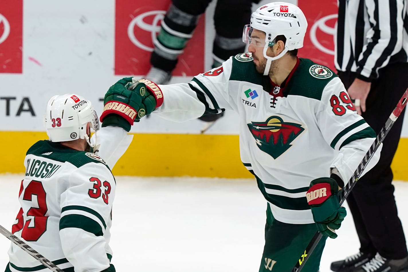 Wild center Frederick Gaudreau is congratulated by teammate Alex Goligoski after Gaudreau scored in the shootout Sunday