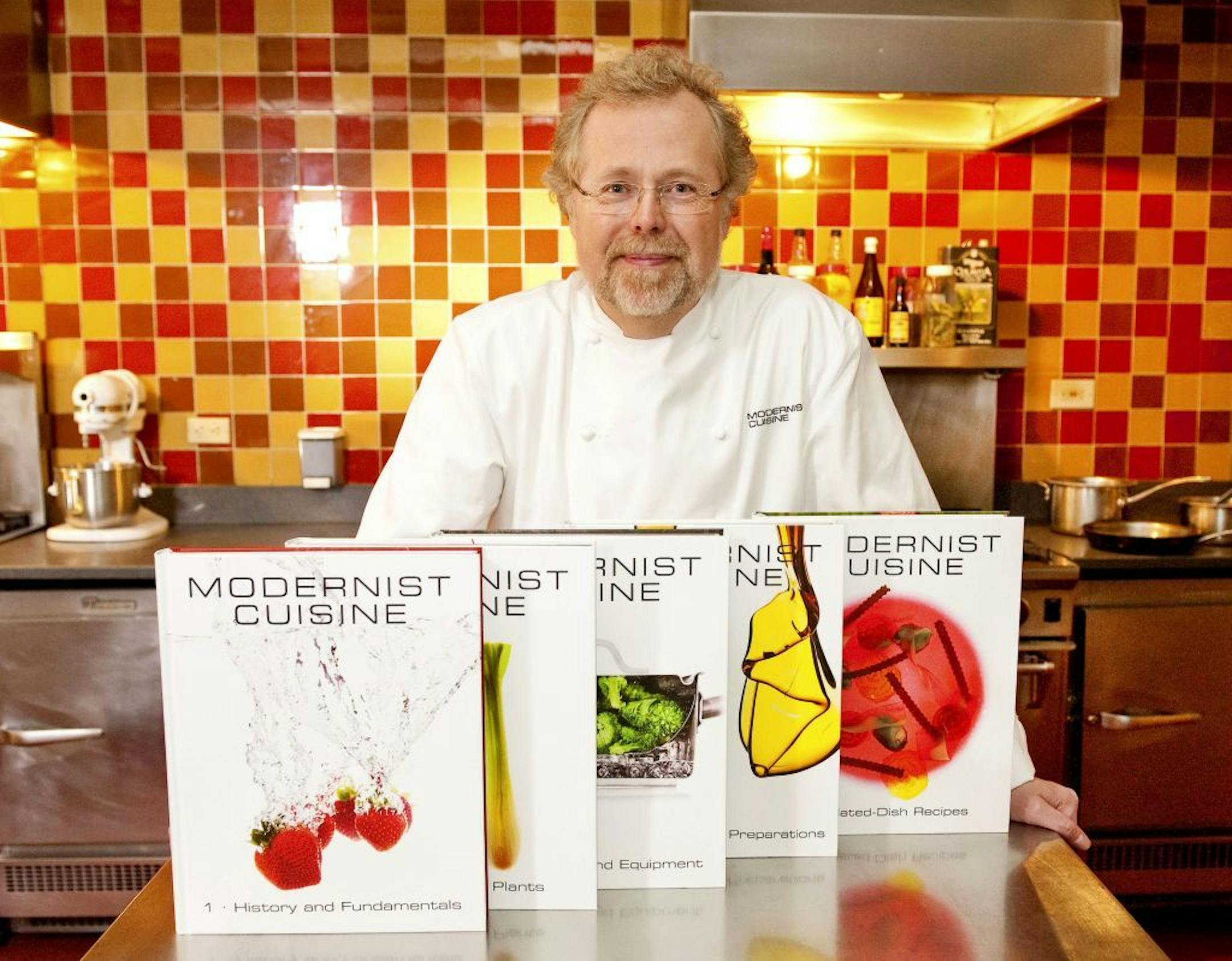 FILE - In this March 23, 2011 file photo, Nathan Myhrvold, author of "Modernist Cuisine: The Art and Science of Cooking," as he poses with five books from the work at the Institute for Culinary Education in New York. On Friday, May 4, 2012, Myhrvold won a James Beard Award for Cookbook of the Year.