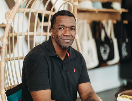photo of author Jason Mott, seated in a rattan chair