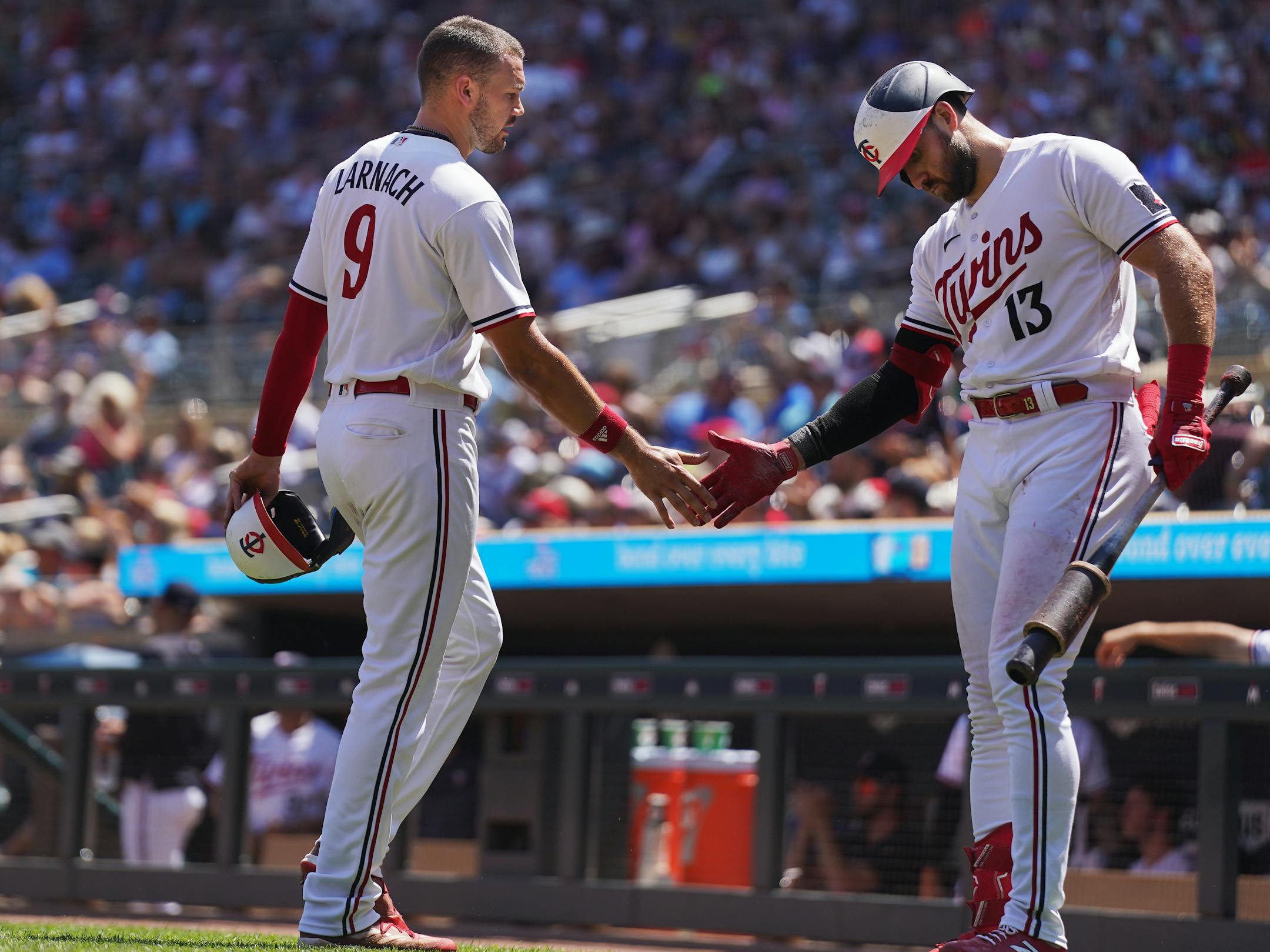 Minnesota Twins left fielder Trevor Larnach (9) scores and is congratulated by Minnesota Twins left fielder Joey Gallo (13) in the sixth inning in Minneapolis, Minn., on Wednesday, July 26, 2023.