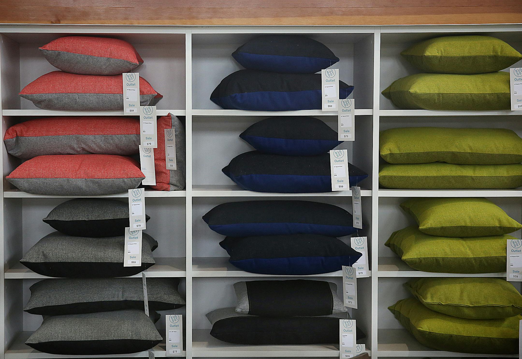 Square pillows are stacked up neatly on shelves at the Blu Dot outlet store in Minneapolis. ] JIM GEHRZ ï james.gehrz@startribune.com / Minneapolis, MN / July 16, 2015 / 11:00 AM ñ BACKGROUND INFORMATION: Local modern furniture manufacturer Blu Dot opens its first outlet store. The Minneapolis store will feature discounted items as well as most of the full-priced line. Co-founder John Christakos talks about his company's growth.