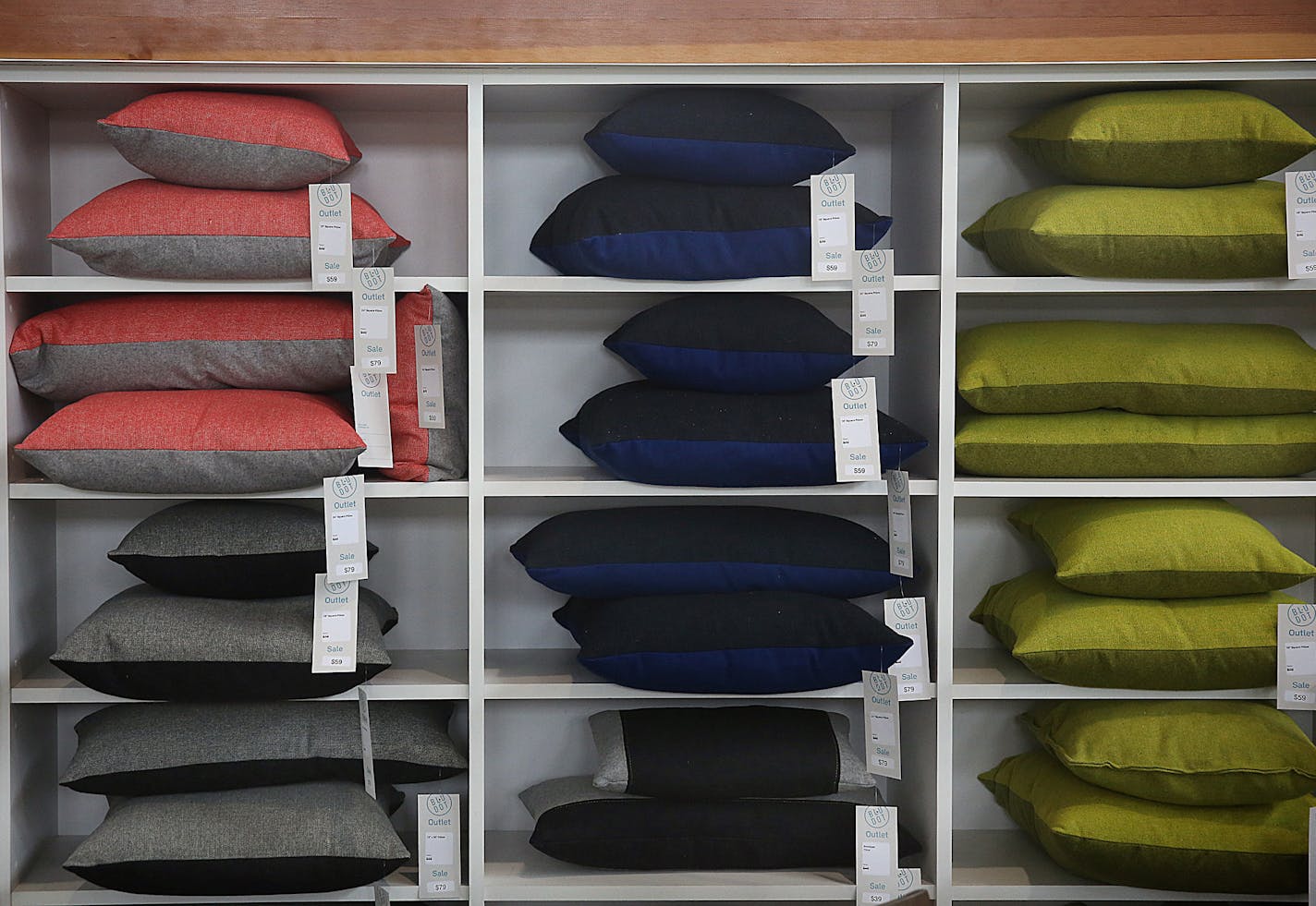 Square pillows are stacked up neatly on shelves at the Blu Dot outlet store in Minneapolis. ] JIM GEHRZ &#xef; james.gehrz@startribune.com / Minneapolis, MN / July 16, 2015 / 11:00 AM &#xf1; BACKGROUND INFORMATION: Local modern furniture manufacturer Blu Dot opens its first outlet store. The Minneapolis store will feature discounted items as well as most of the full-priced line. Co-founder John Christakos talks about his company's growth.