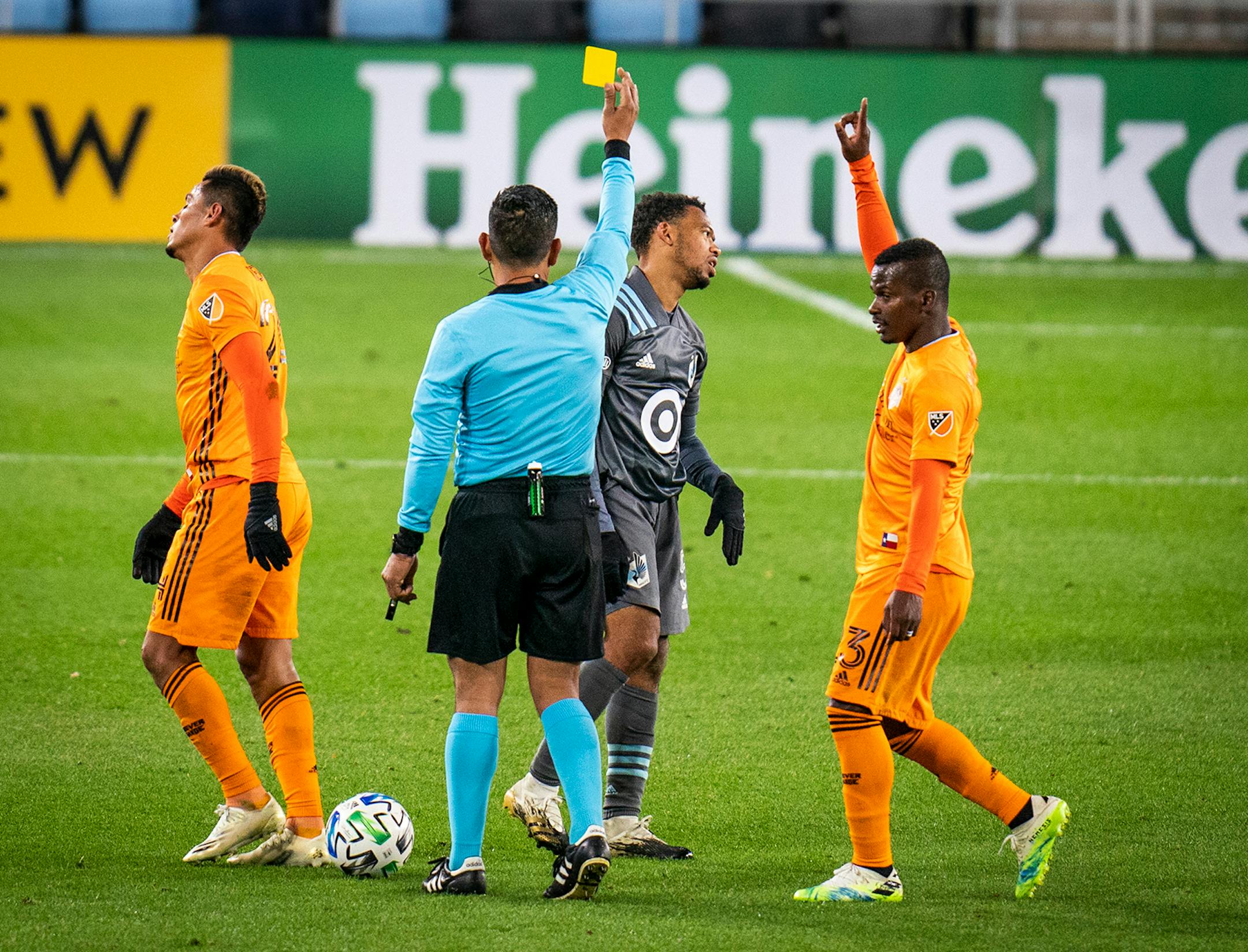 Minnesota United midfielder Jacori Hayes (5) received a yellow card against Houston Dynamo midfielder Darwin Ceren (24), left, as Houston Dynamo forward Darwin Quintero (23) celebrated during the second half.