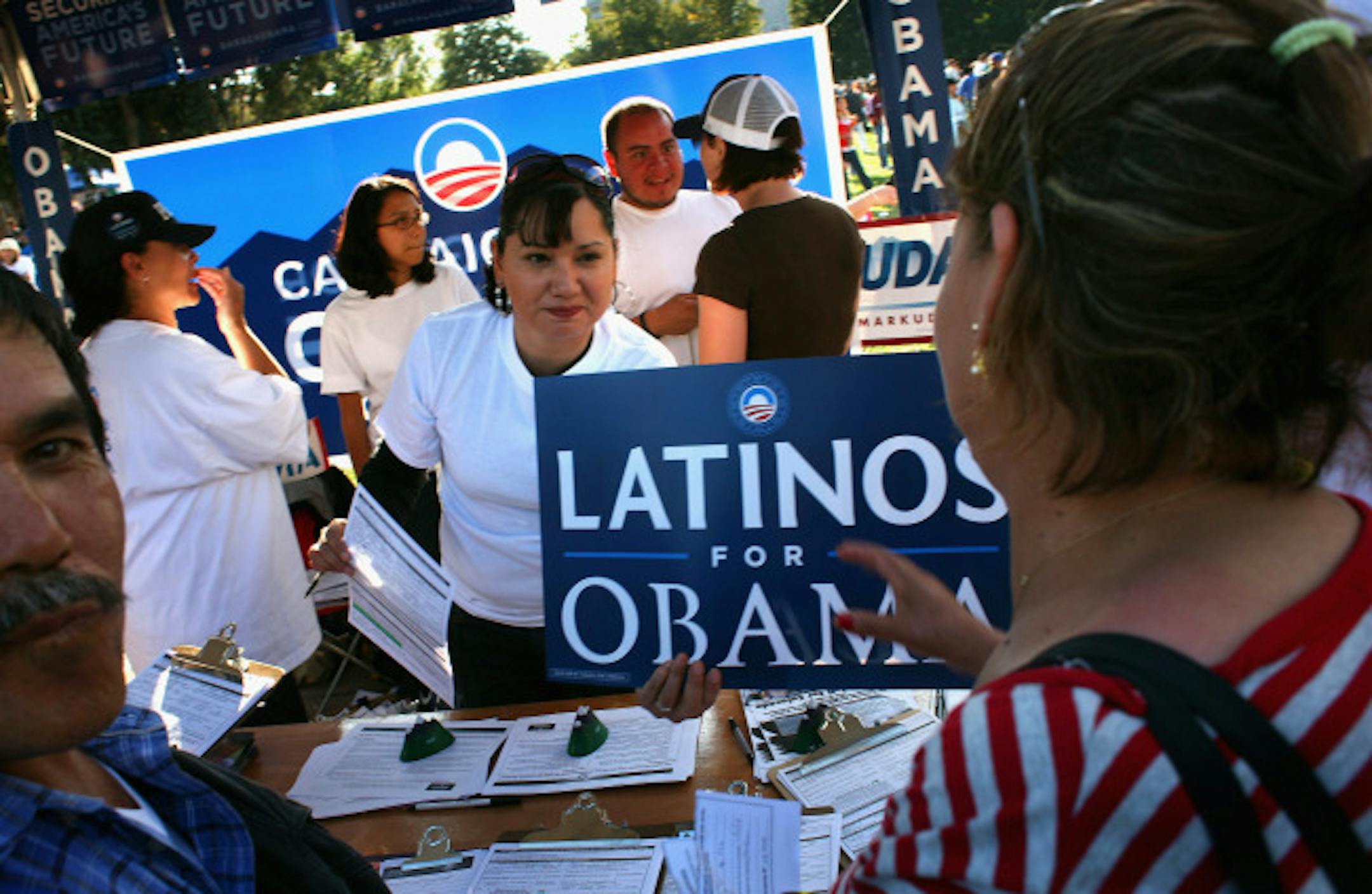 DENVER - SEPTEMBER 14: Democratic Party workers hand out signs at a celebration marking Mexican Independence Day September 14, 2008 in Denver, Colorado. The Democratic Party is working hard to register Latino voters in Colorado, which will be an important swing state in November's presidential election.