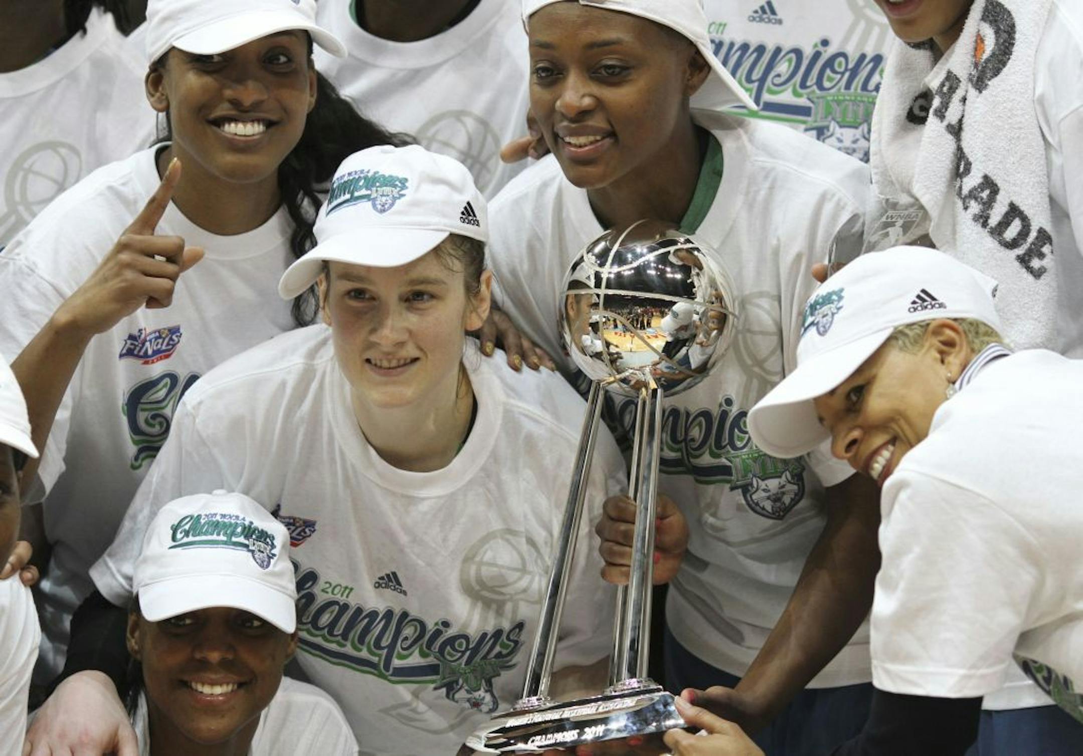 Lynx players and coaches clurtched the WNBA championship trophy and posed for photos after beating Atalnta 73-67 on Friday night.