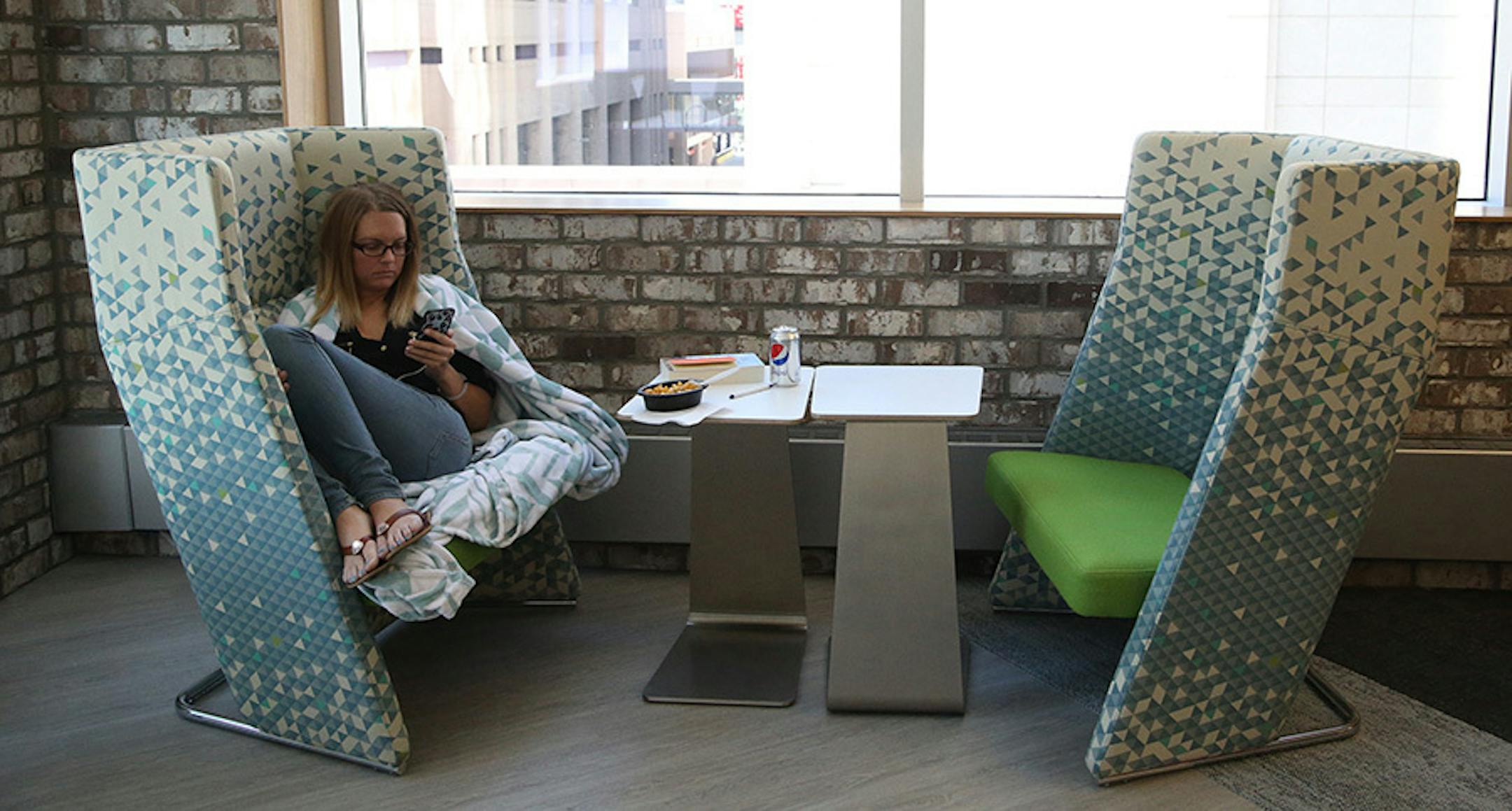 Kelly Porter, library assistant, got cozy while taking her lunch break in one of the eating areas on the newly redesigned fourth floor.