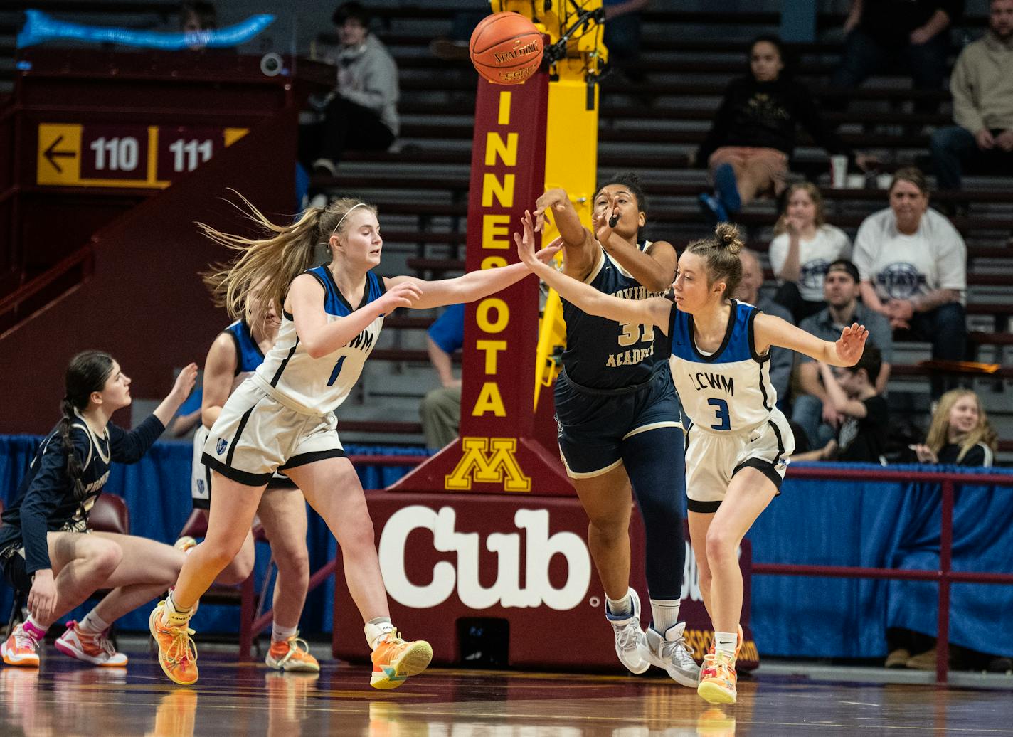 Kyra Miller, of Providence Academy passed the ball down court around Olivia Harazin, left and Ella Voges, of Lake Crystal-Welcome at Willams Arena Wednesday ,March, 15,2023 in Minneapolis, Minn.] JERRY HOLT • jerry.holt@startribune.com