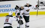 Minnesota Wild center Eric Staal (12) celebrates his goal with teammates Nino Niederreiter (22) and Zach Parise (11) during the third period of an NHL