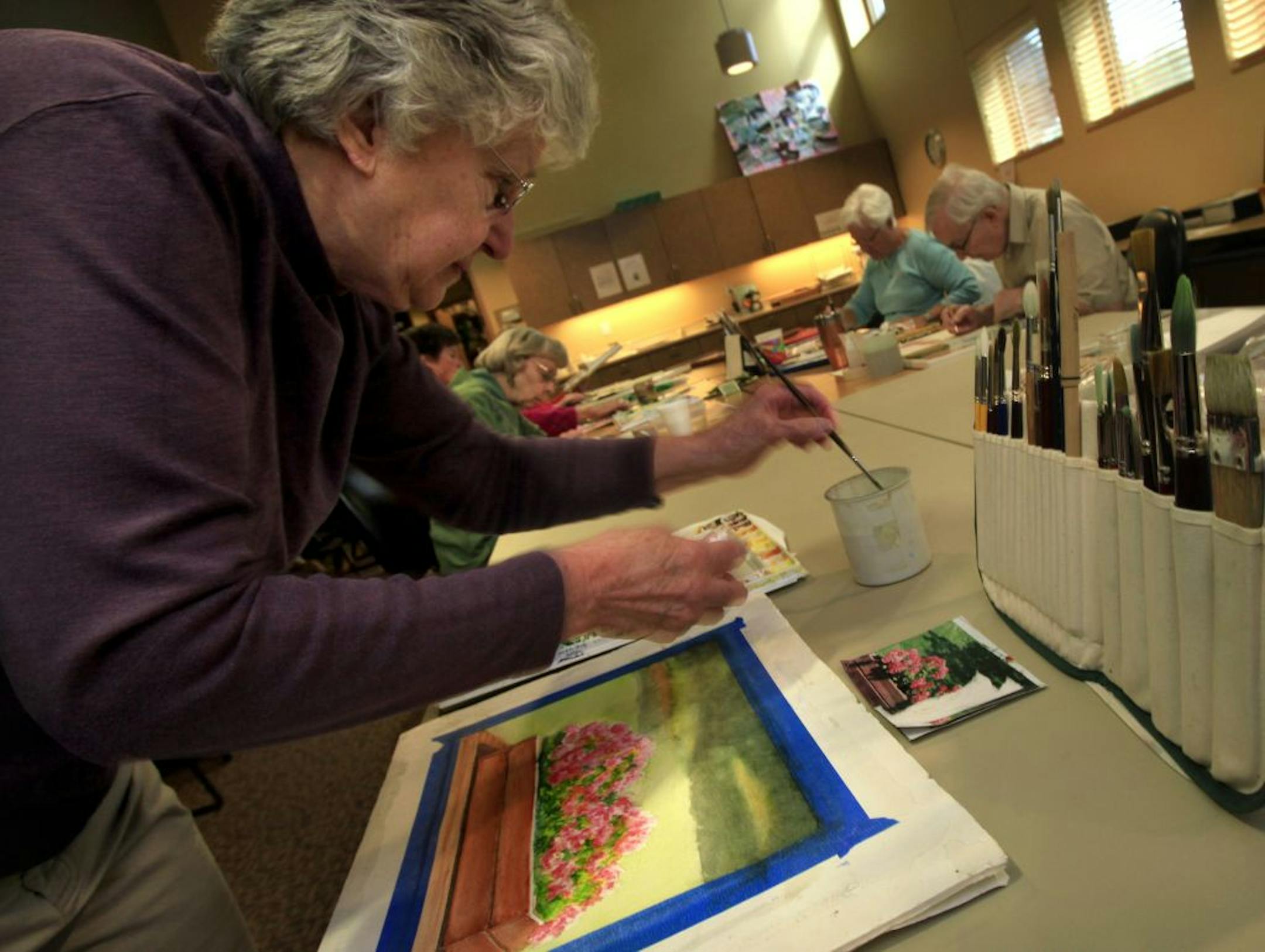 Jean DeFranco (foreground)Gene Saylor (green shirt ), Ruth King (left pink shirt), , Sandy Fletcher (blue shirt) and Art Thell work on their watercolor paintings at the Thompson County Park Lodge in West St. Paul on March 17, 2012.